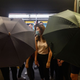 Protesters use umbrellas to shield themselves during a protest to prevent commuters from reaching work at Lai King MTR station in Hong Kong on Aug. 5, 2019.